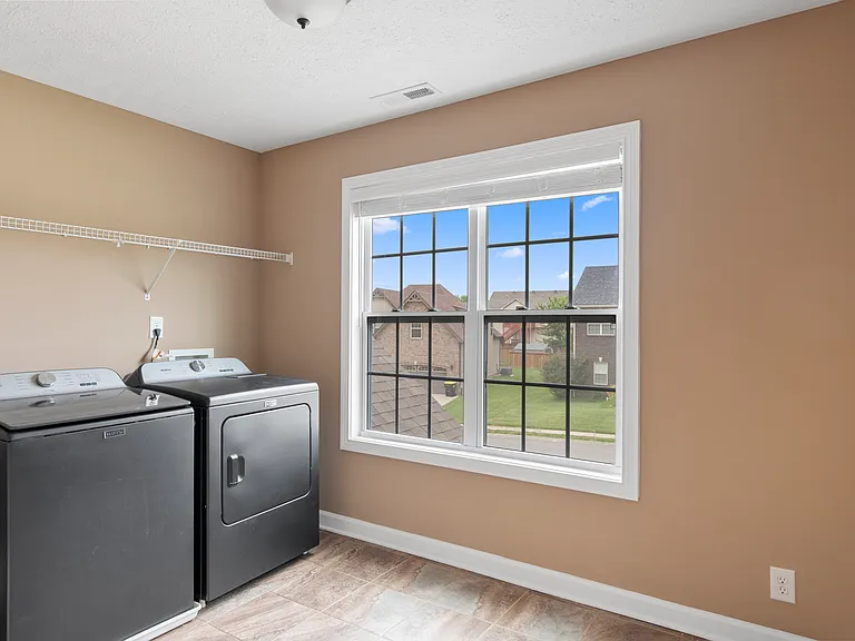 Huge, tiled Laundry Room upstairs (includes less than 1 year old, virtually unused Whirlpool washer and dryer)