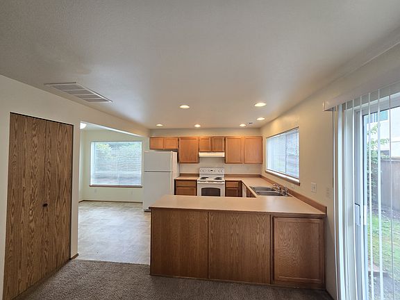 Light and bright kitchen with plenty of space and full pantry.