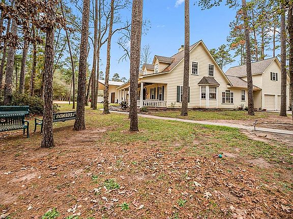 COUNTRY LIVING BUT CLOSE TO THE CITY: A private driveway securely gated leads you into this awesome home. Country living with all the city amenities like grocery stores, restaurants, golf courses, Lake Conroe, just minutes away.