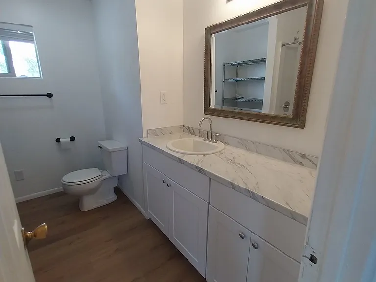 New vanity and sink with large mirror in main hall bath