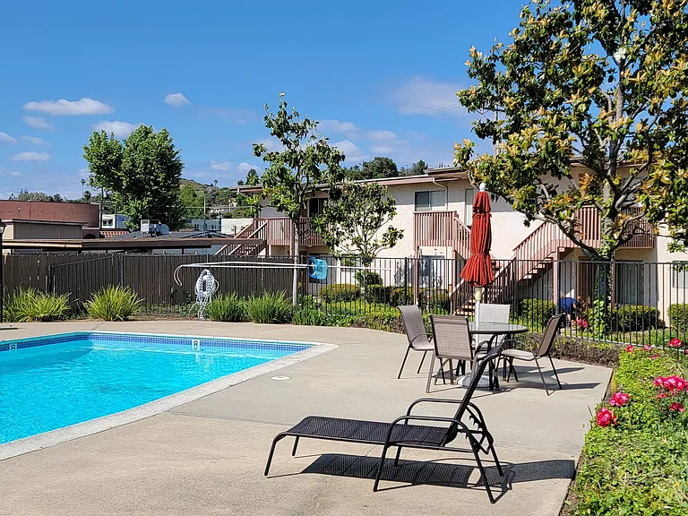Crystal clear swimming pool and sun deck at Plaza Verde Apartments in Escondido, California.