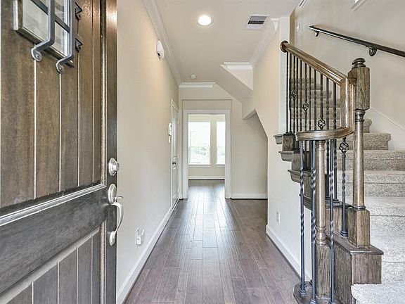 Stunning front door opens up to bright entryway and beautiful staircase