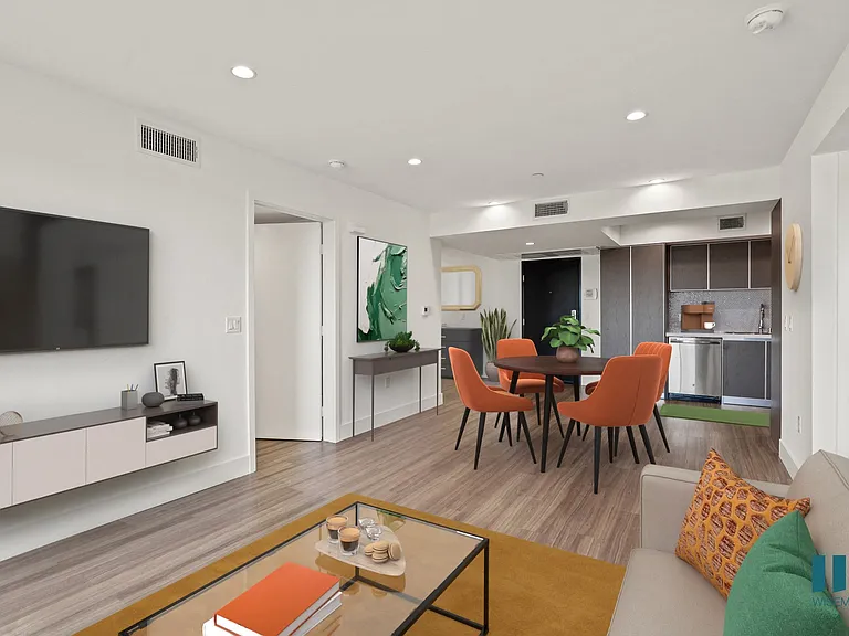 Open-Concept Kitchen, Dining, and Living Room Space with Vinyl Flooring and Recessed Lighting