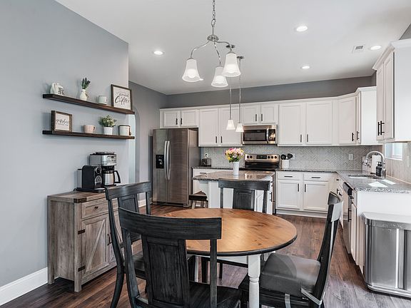 Extended kitchen area with a nice coffee bar. Access to the back yard to the right.