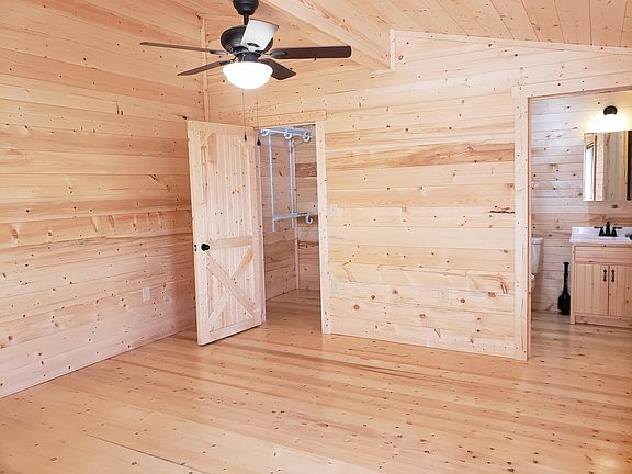 Bedroom with ceiling fan, walk-in closet and full bath