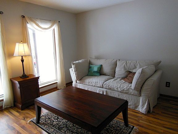 The charming living room features large windows and laminate floors.  The interior of the home has been freshly painted. 