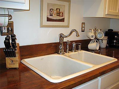 Kohler sink wrapped in cedar countertop.