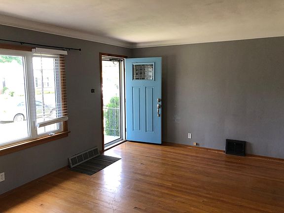 Living room with large picture window and crown molding.