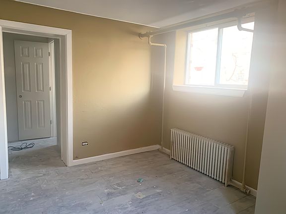 living area leading into kitchen & bathroom