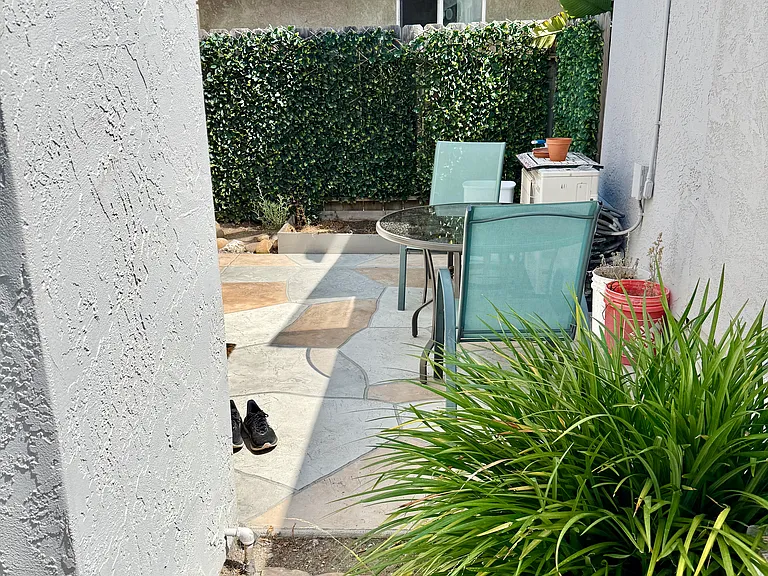walkway to sitting private sitting area adjacent to sliding glass door to kitchen