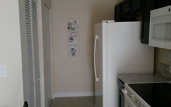 Kitchen side view. Door to Washer/Dryer