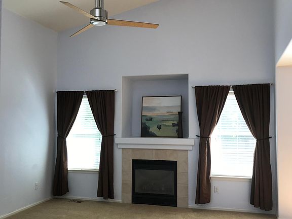 Vaulted ceilings in carpeted living room.