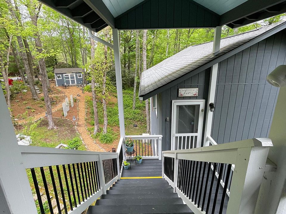 Stairs down to Airbnb then on down to small Executive Apartment. She shed and property paths in the background.