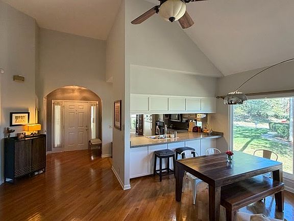 Looking at front door and into kitchen from living room