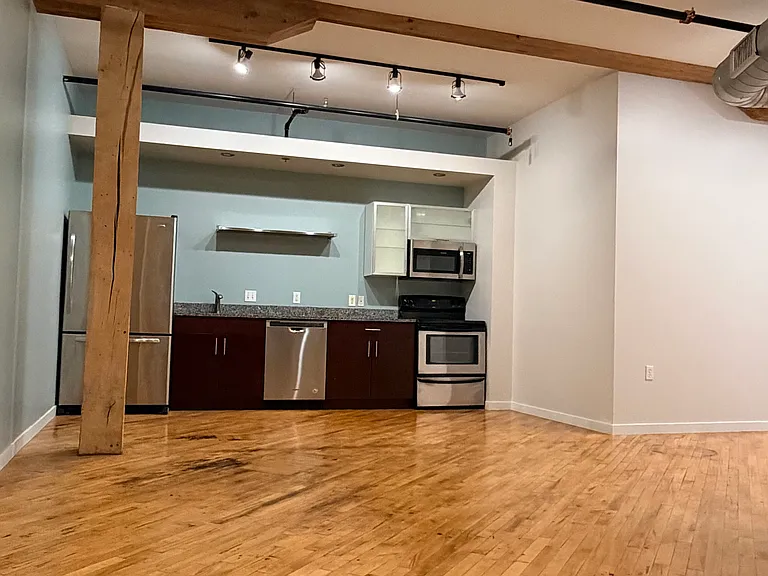 Kitchen/Dining area (Photos of similar unit with same floor plan. Unit 211 will have higher exposed beam ceilings. Colors, finishes, and fixtures may vary)