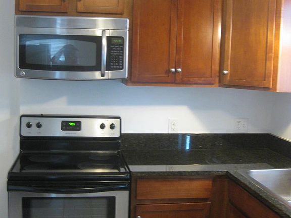 built in microwave, granite countertops, smoothtop range