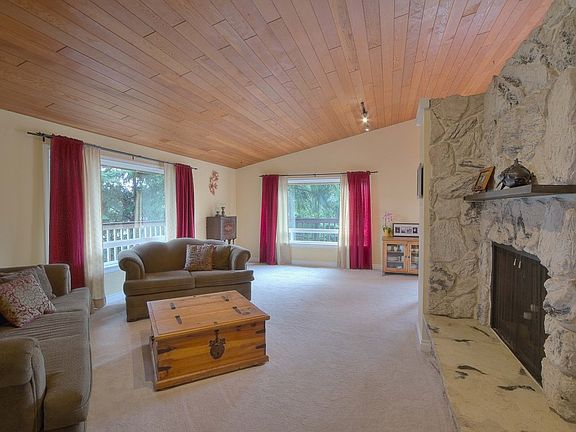 Large livingroom with majestic rock fireplace and vaulted ceilings are two of the many highlights of