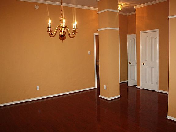 Formal dining area is open and has architectural columns