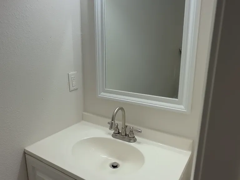 Updated vanity with bright lighting and a clean mirror setup - fresh, simple, and ready to use.