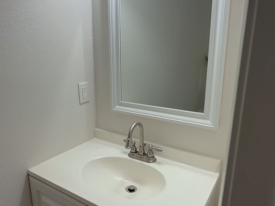 Updated vanity with bright lighting and a clean mirror setup - fresh, simple, and ready to use.