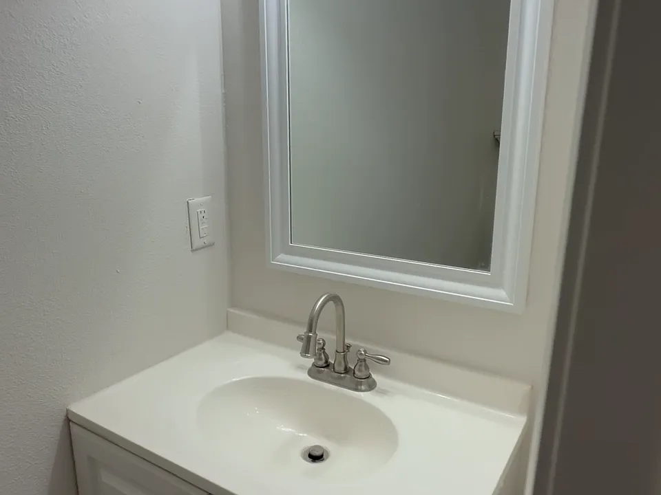 Updated vanity with bright lighting and a clean mirror setup - fresh, simple, and ready to use.