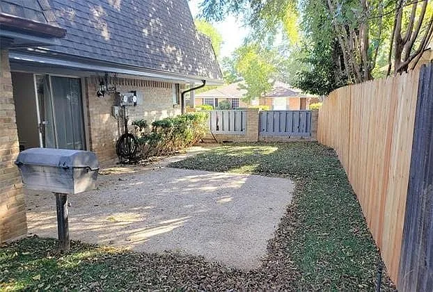 Faux grass in the side yard and BBQ grill.