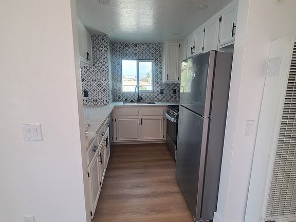 Kitchen with all new appliances, including a large refrigerator