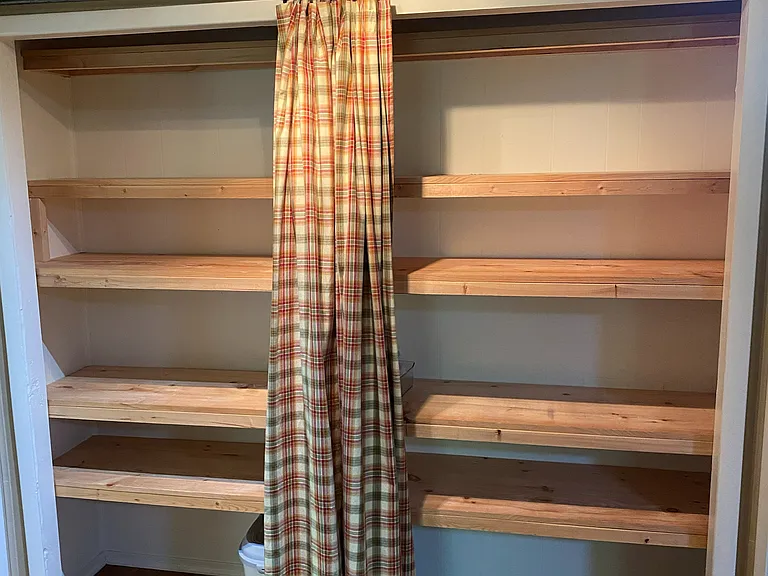 (2 of 2) Built in shelving/pantry in the kitchen area.