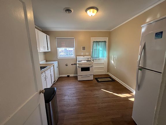 Kitchen with back door. Gas range n oven. Refrigerator freezer. Small area for table and couple of chairs. Led lighting thru out the house.