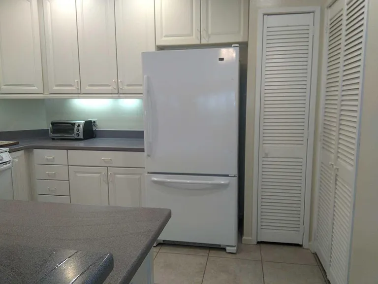 OPEN KITCHEN FEATURING PANTRY AND WALK IN LAUNDRY/PANTRY TO THE RIGHT