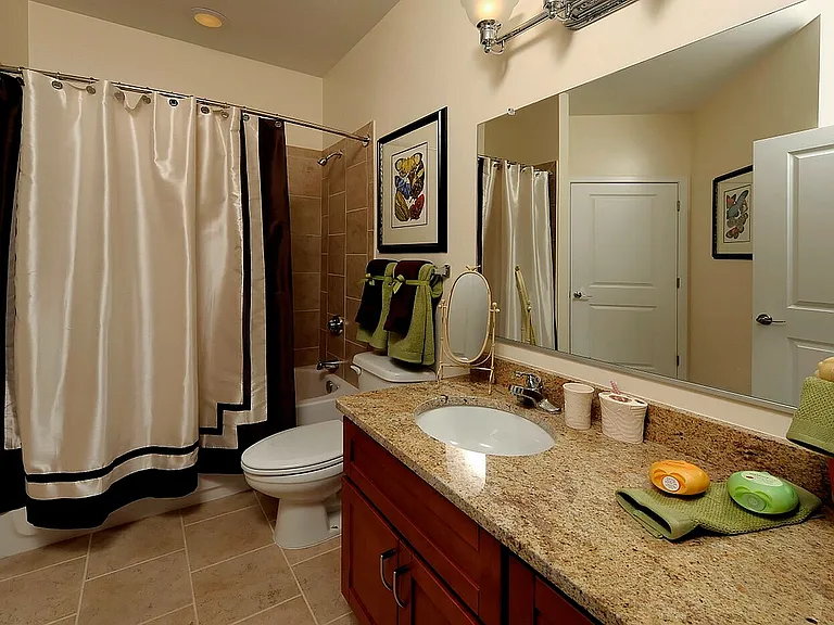 Spacious Bathroom With Granite Vanity Top & Ample Storage Space