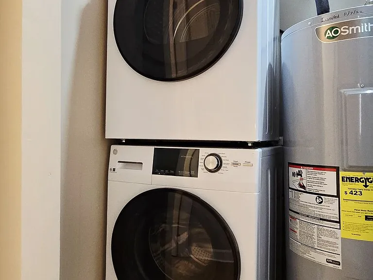 Convenient in-unit laundry with stacked washer and dryer.