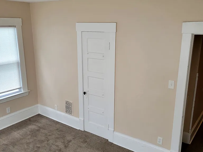 Bedroom 1 -view of entry door and closet