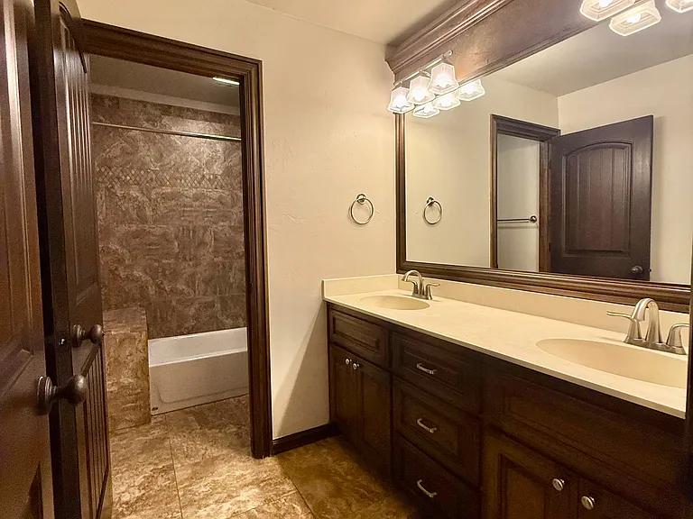 This bathroom has a double vanity and lots of storage. An extra door separates the sinks from the shower/tub and toilet. I love this layout for multiple family members to get ready at the same time. Bathroom has new updated colors to brighten up the room.