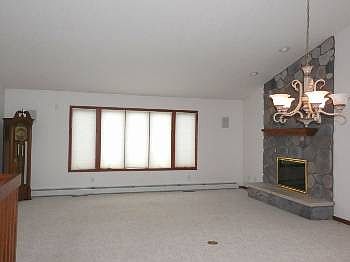 Very spacious open living room offers beautiful stone gas fireplace