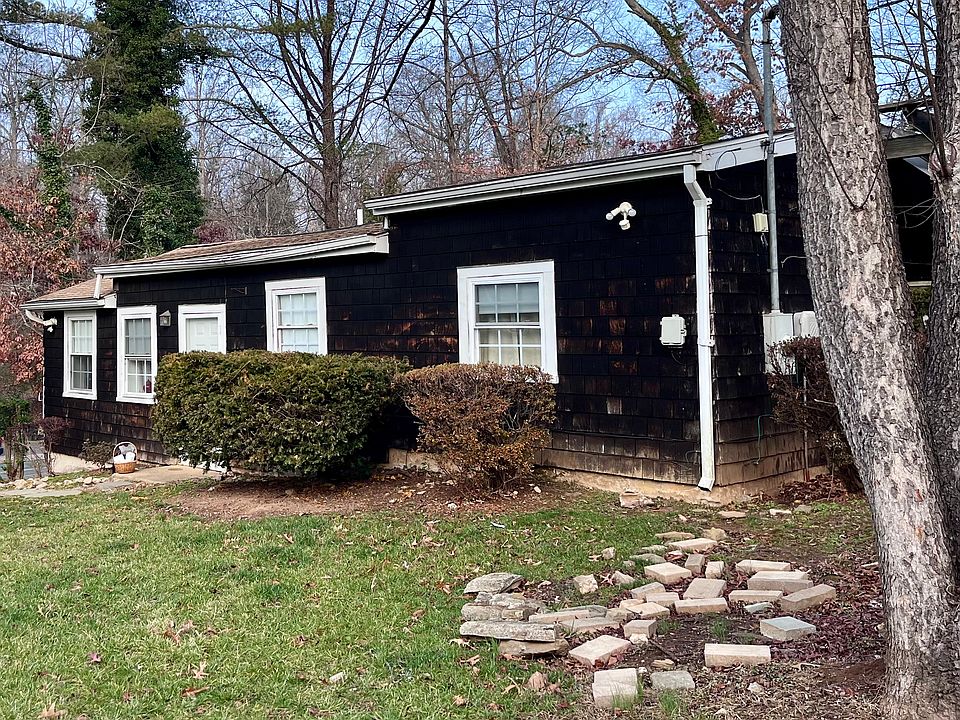 Front of Cottage faces garden. Side of Cottage overlooks Parking Area and Street.