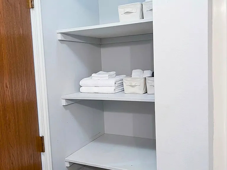 Closet aisle between bedrooms
