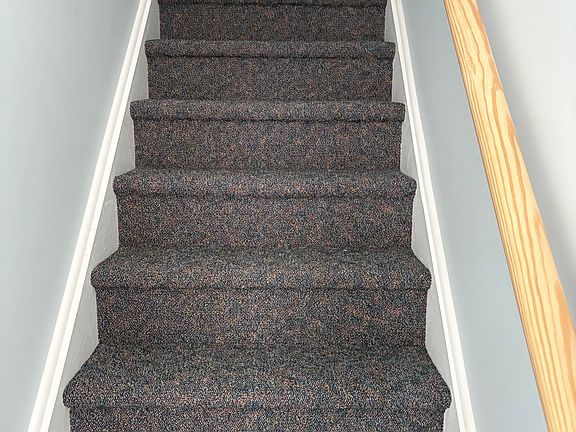 The carpeted steps that lead upstairs