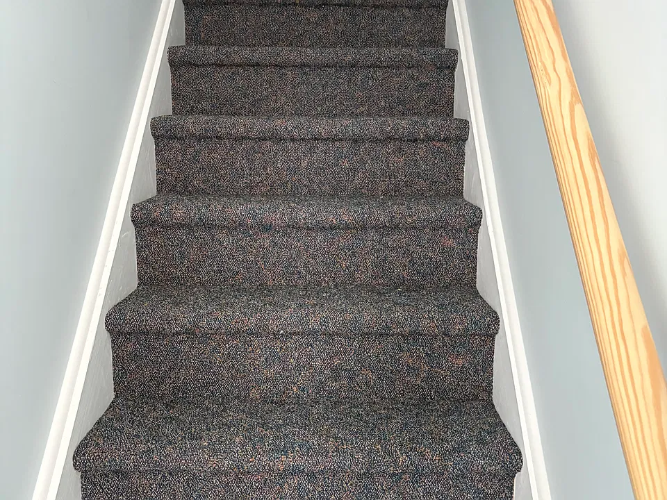 The carpeted steps that lead upstairs