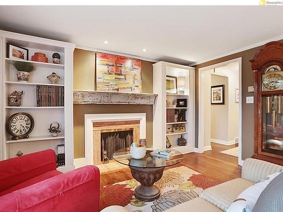 Cozy formal living room with built-ins and fireplace with ma