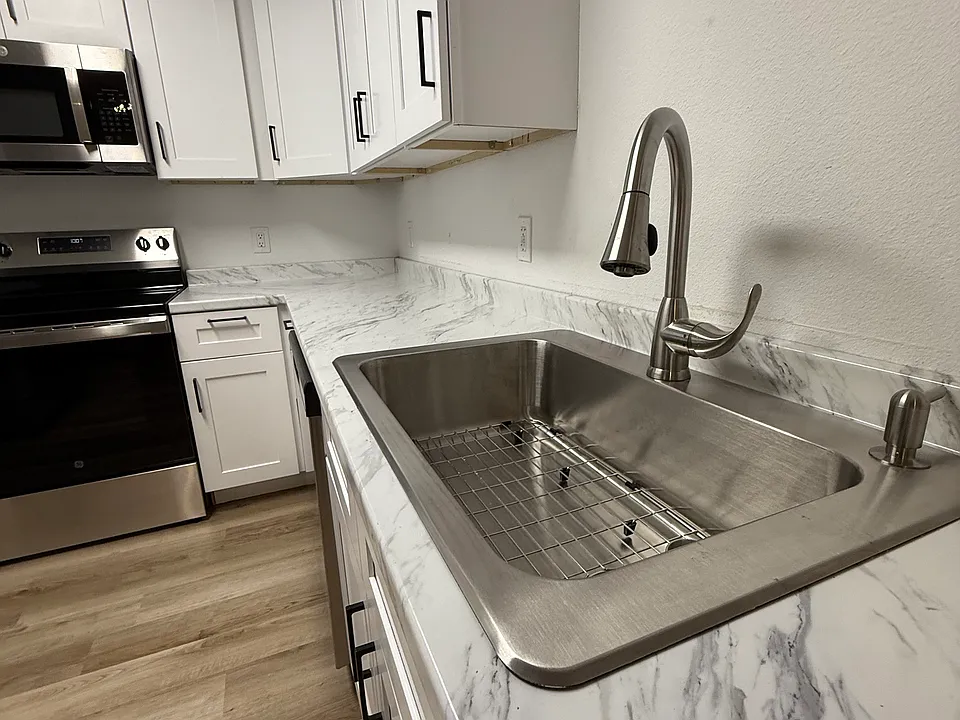 Farmhouse sink in fully remodeled kitchen
