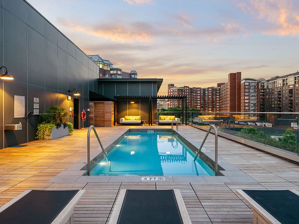Rooftop lounge area featuring poolside seating and cabanas