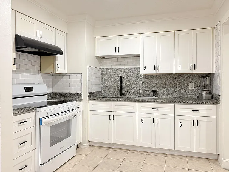 Kitchen with dedicated cabinet and refrigerator space for each room.