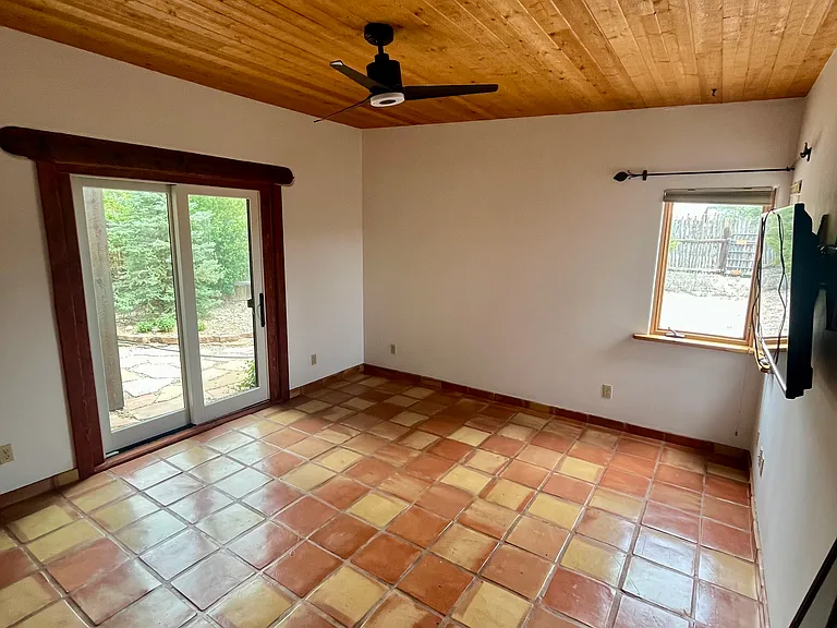 French doors off the bedroom open to the xeriscaped lawn.