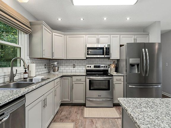 Large kitchen with stainless steel appliances and granite countertops