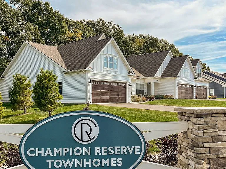 Exterior of Champion Reserve Townhomes near the Gillis Road entrance. White townhomes with attached 2-car garages.
