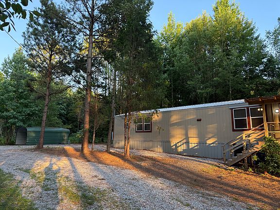view of front yard, parking and carport