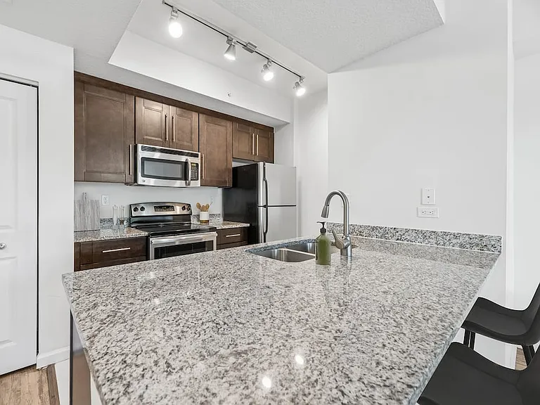 Classic Package kitchen with stainless steel appliances, granite countertops (in most homes), and oak cabinetry