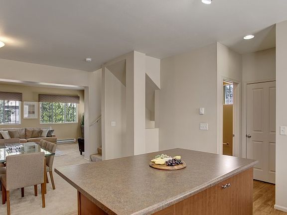 Kitchen with Built-In Island and Dining with Carpet Flooring