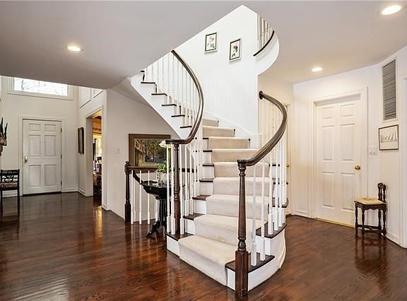 Beautiful hardwood floors surround the grand staircase.